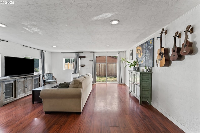 living room with dark hardwood / wood-style floors and a textured ceiling