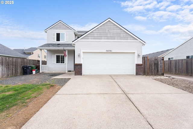 view of front of house featuring brick siding, concrete driveway, covered porch, an attached garage, and fence