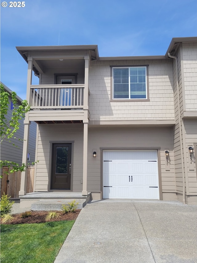 850 NE 14th St, Battle Ground, WA 98604 - back of house featuring a balcony, fence, an attached garage, and concrete driveway