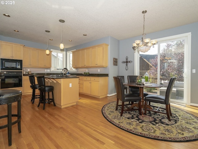 2600 Umpqua Ln, West Linn, OR 97068 - kitchen featuring black appliances, light brown cabinets, a textured ceiling, a chandelier, and light wood-style flooring