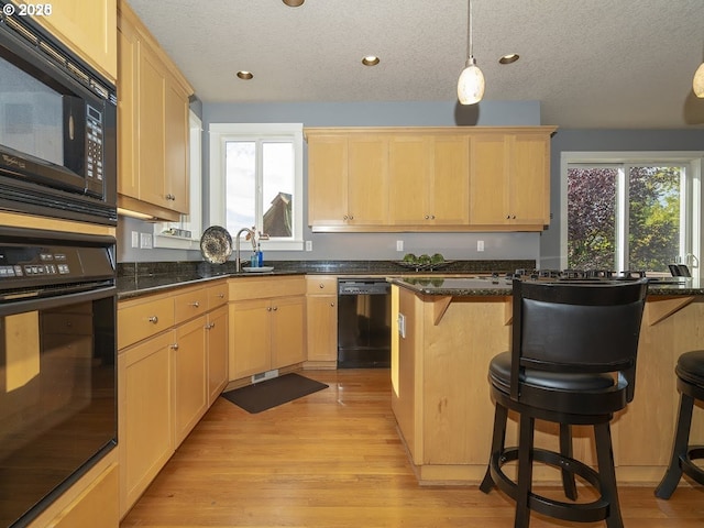 2600 Umpqua Ln, West Linn, OR 97068 - kitchen featuring black appliances, light brown cabinetry, healthy amount of natural light, a textured ceiling, and recessed lighting