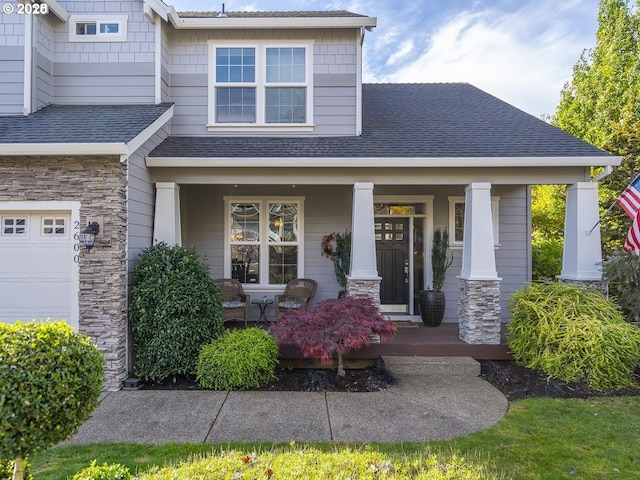 2600 Umpqua Ln, West Linn, OR 97068 - view of front of home with covered porch, a shingled roof, stone siding, and a garage