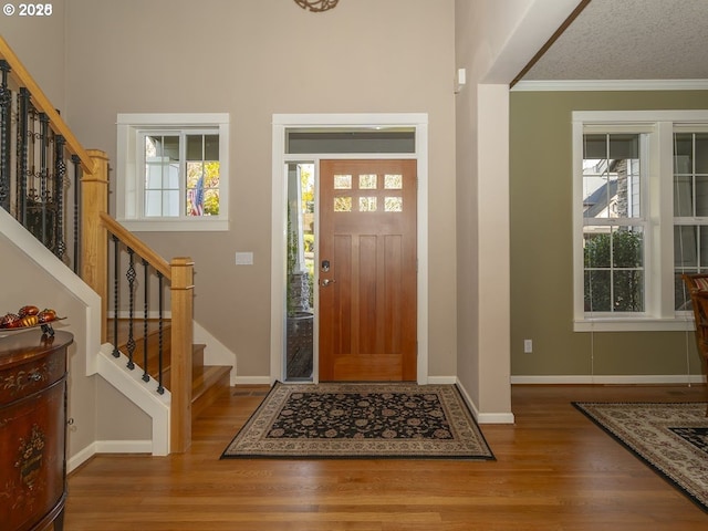 2600 Umpqua Ln, West Linn, OR 97068 - entryway featuring wood finished floors, stairs, crown molding, and baseboards