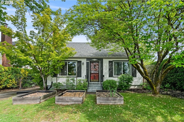 3416 SE 63rd Ave, Portland, OR 97206 - view of front facade featuring a vegetable garden, a front yard, and roof with shingles
