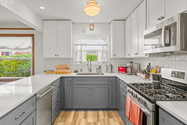 3416 SE 63rd Ave, Portland, OR 97206 - kitchen with appliances with stainless steel finishes, gray cabinetry, a sink, and recessed lighting