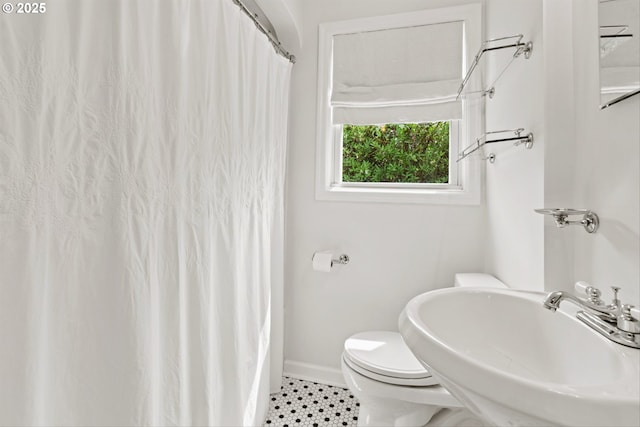 3416 SE 63rd Ave, Portland, OR 97206 - bathroom with a sink, baseboards, toilet, and tile patterned flooring