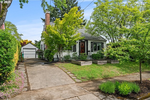 3416 SE 63rd Ave, Portland, OR 97206 - view of front of home featuring a front yard, an outbuilding, a chimney, a detached garage, and driveway