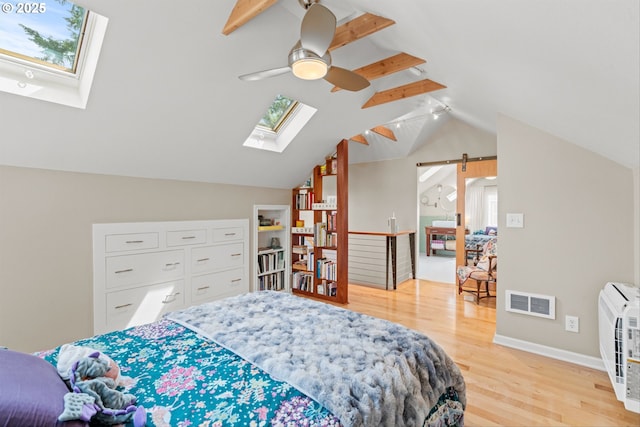 3416 SE 63rd Ave, Portland, OR 97206 - bedroom featuring a skylight, lofted ceiling, light wood-style floors, multiple windows, and baseboards