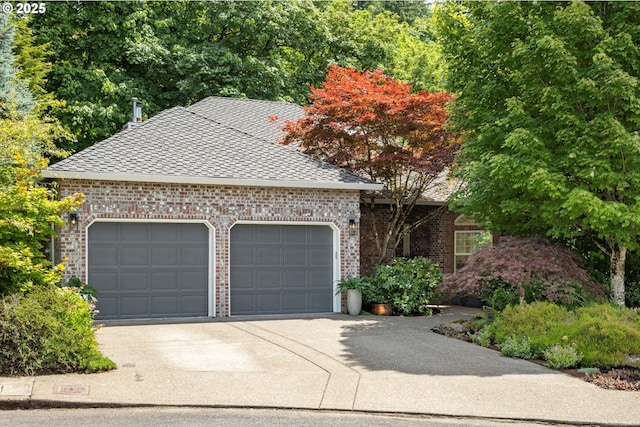 1911 NW Norfolk Ct, Portland, OR 97229 - view of front of house featuring brick siding, a garage, concrete driveway, and a shingled roof