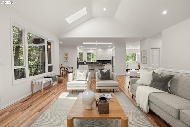 1911 NW Norfolk Ct, Portland, OR 97229 - living area featuring radiator, recessed lighting, lofted ceiling, light wood-style floors, and a skylight
