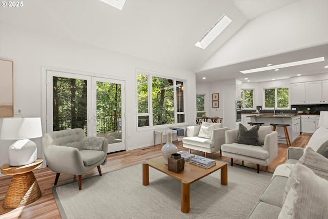 1911 NW Norfolk Ct, Portland, OR 97229 - living area with a skylight, light wood-style flooring, high vaulted ceiling, and recessed lighting