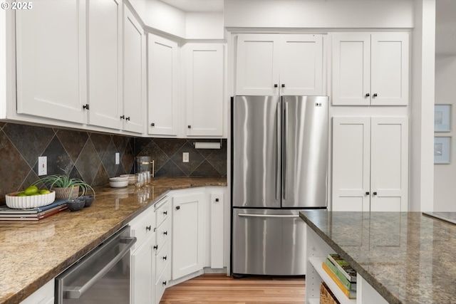 1911 NW Norfolk Ct, Portland, OR 97229 - kitchen with appliances with stainless steel finishes, dark stone counters, and white cabinetry