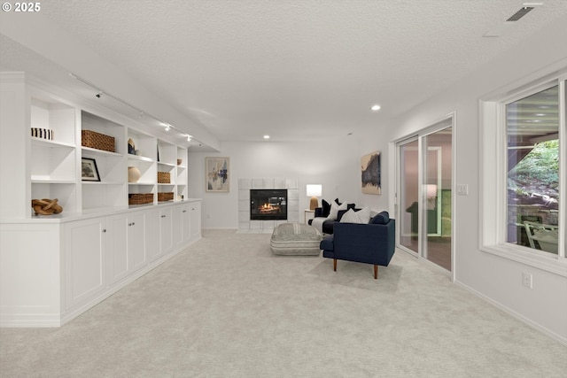 1911 NW Norfolk Ct, Portland, OR 97229 - living area with a fireplace, a textured ceiling, light colored carpet, recessed lighting, and rail lighting