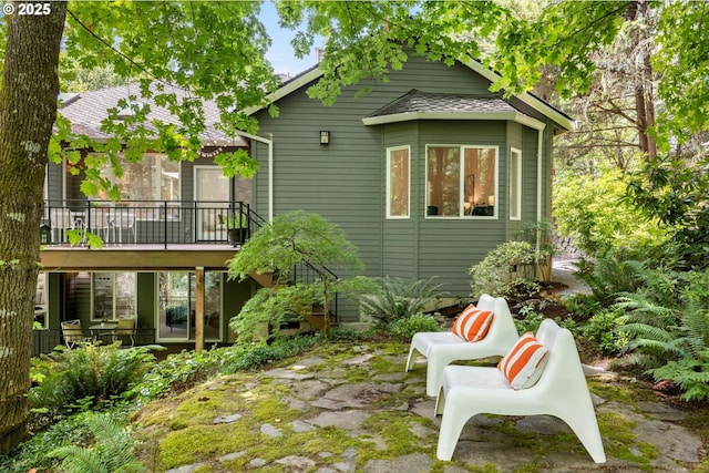 1911 NW Norfolk Ct, Portland, OR 97229 - rear view of house with a shingled roof and a patio