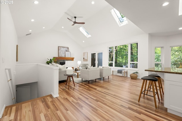 1911 NW Norfolk Ct, Portland, OR 97229 - living room featuring a skylight, recessed lighting, light wood-style floors, a ceiling fan, and high vaulted ceiling
