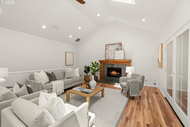 1911 NW Norfolk Ct, Portland, OR 97229 - living area with lofted ceiling, light wood-style floors, a tile fireplace, and recessed lighting