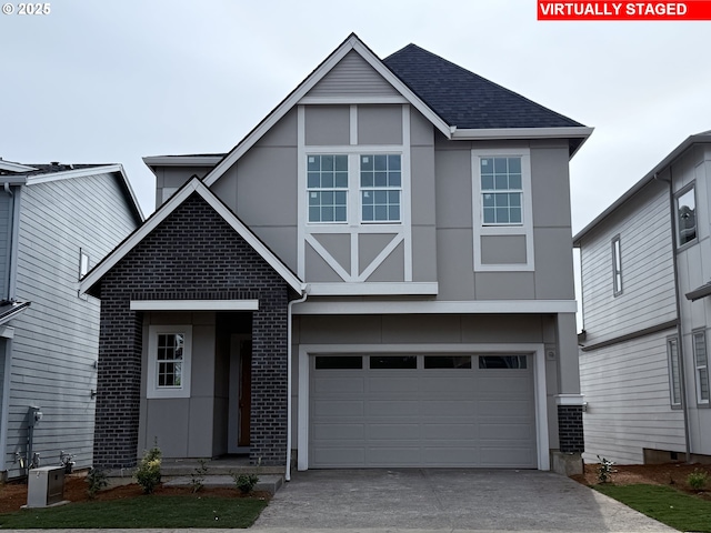 view of front of home with stucco siding, roof with shingles, concrete driveway, an attached garage, and brick siding