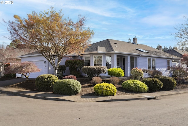 view of home's exterior featuring a chimney, a shingled roof, and a garage