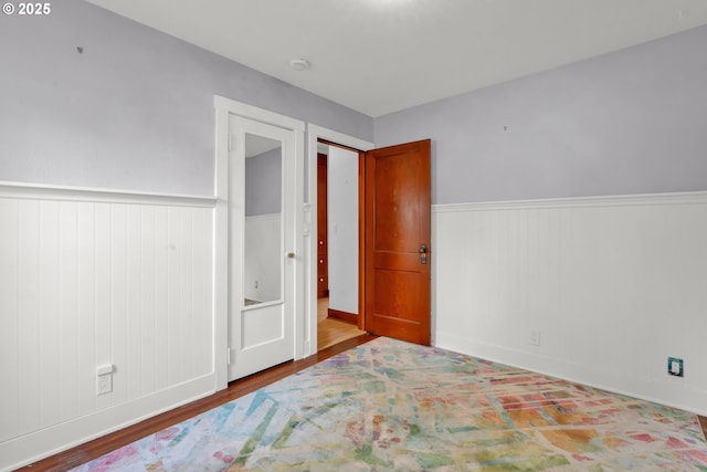 1710 Norkenzie Rd, Eugene, OR 97401 - bedroom with wainscoting and wood finished floors
