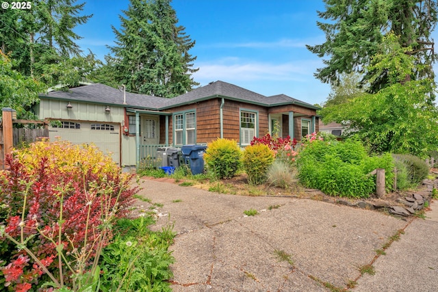1710 Norkenzie Rd, Eugene, OR 97401 - view of front of house featuring an attached garage, driveway, and a shingled roof