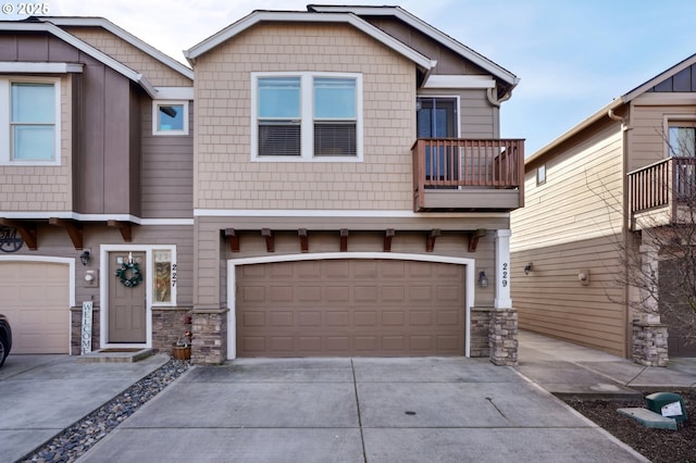 229 N 33rd Ct, Ridgefield, WA 98642 - craftsman inspired home with stone siding, driveway, a balcony, and an attached garage