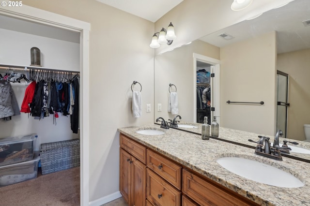 229 N 33rd Ct, Ridgefield, WA 98642 - bathroom with double vanity, a shower stall, a walk in closet, and baseboards