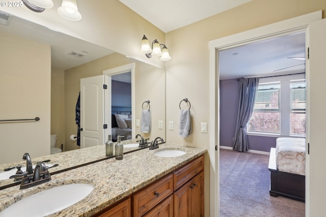 229 N 33rd Ct, Ridgefield, WA 98642 - ensuite bathroom featuring baseboards, toilet, and double vanity