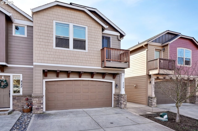 229 N 33rd Ct, Ridgefield, WA 98642 - craftsman house featuring driveway, a balcony, an attached garage, and stone siding