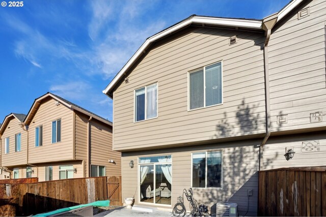 229 N 33rd Ct, Ridgefield, WA 98642 - back of house featuring central AC, a patio area, fence, and a gate