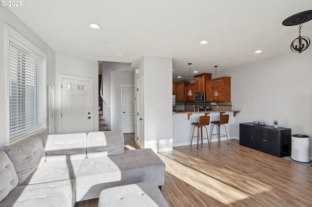 229 N 33rd Ct, Ridgefield, WA 98642 - living room with recessed lighting, light wood-style floors, stairs, and baseboards