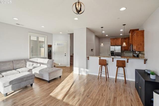 229 N 33rd Ct, Ridgefield, WA 98642 - living room with light wood-type flooring, recessed lighting, and baseboards