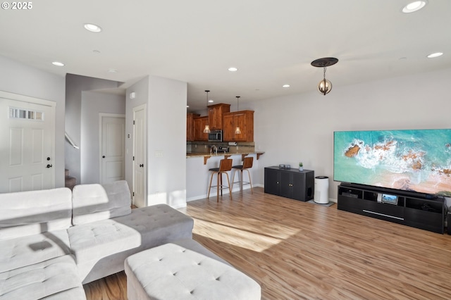 229 N 33rd Ct, Ridgefield, WA 98642 - living room with recessed lighting, light wood-style floors, stairs, and baseboards