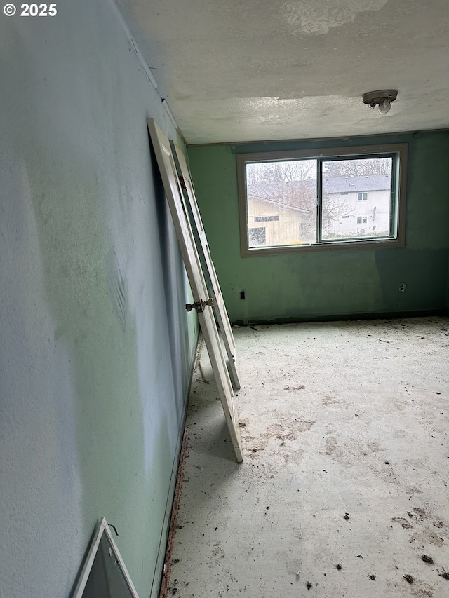 unfurnished room featuring a textured ceiling