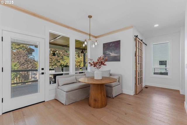 dining space featuring crown molding, wood finished floors, baseboards, and breakfast area