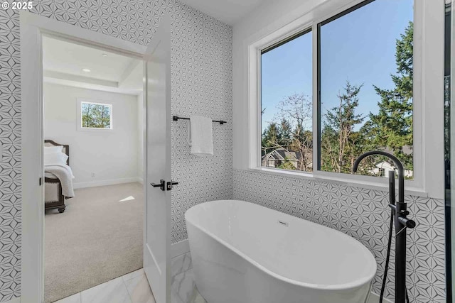 full bath with a freestanding tub and french doors