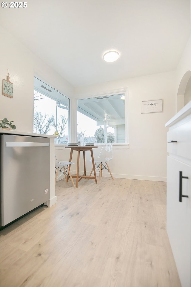 interior space featuring light wood-type flooring and baseboards