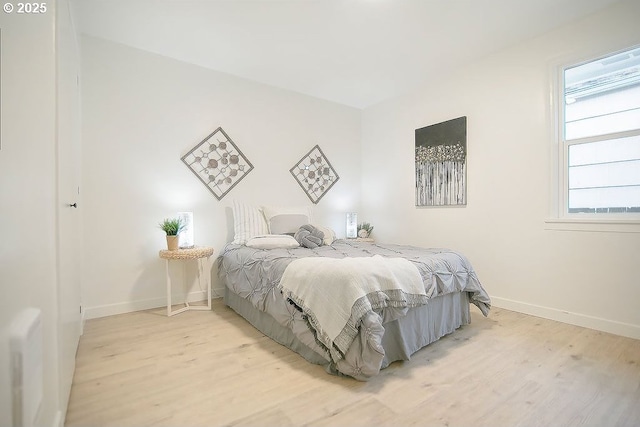 bedroom with baseboards and light wood-style floors