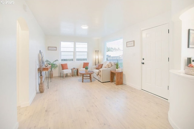 living area featuring light wood finished floors and baseboards