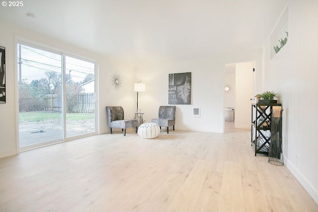 sitting room with light wood-type flooring and visible vents