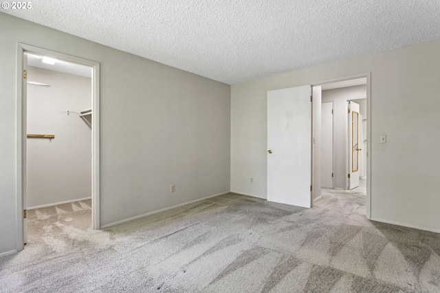 6095 SW Erickson Ave, Beaverton, OR 97008 - unfurnished bedroom featuring a spacious closet, carpet floors, a textured ceiling, and a closet