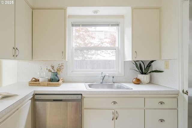 2416 SE 60th Ave, Portland, OR 97206 - kitchen with stainless steel dishwasher, light countertops, backsplash, and cream cabinetry