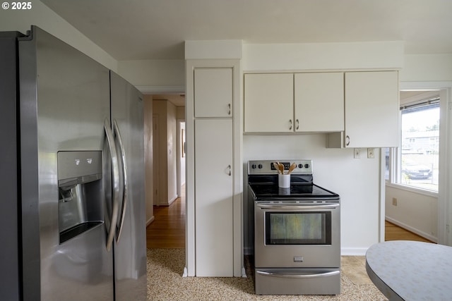 2416 SE 60th Ave, Portland, OR 97206 - kitchen featuring appliances with stainless steel finishes and white cabinetry