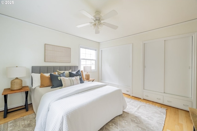 2416 SE 60th Ave, Portland, OR 97206 - bedroom with multiple closets, a ceiling fan, and light wood-style floors