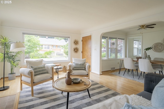 2416 SE 60th Ave, Portland, OR 97206 - living room with light wood finished floors, arched walkways, and a ceiling fan