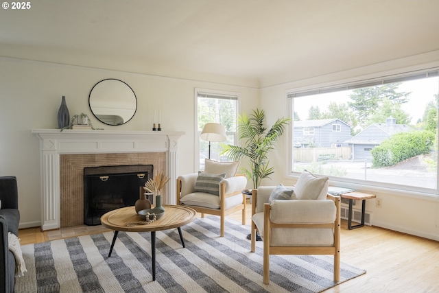 2416 SE 60th Ave, Portland, OR 97206 - living room with a tile fireplace and light wood-style flooring