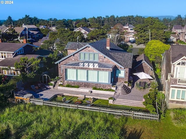 486 N Ocean Ave, Gearhart, OR 97138 - back of house with a patio area, a fenced backyard, a residential view, and a chimney