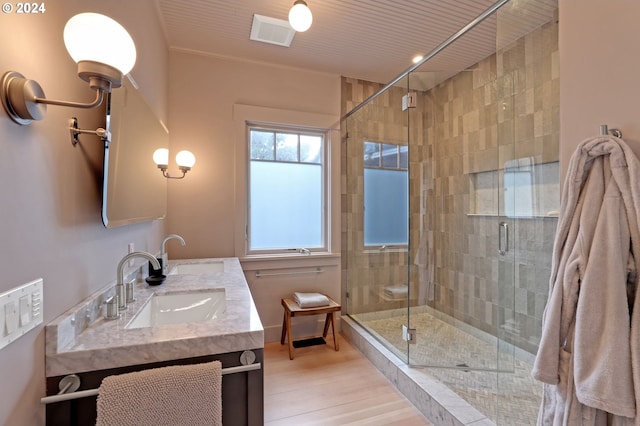 486 N Ocean Ave, Gearhart, OR 97138 - full bathroom featuring a shower stall, double vanity, a sink, and wood finished floors
