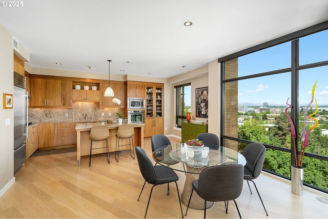 dining area featuring light wood-style floors and recessed lighting