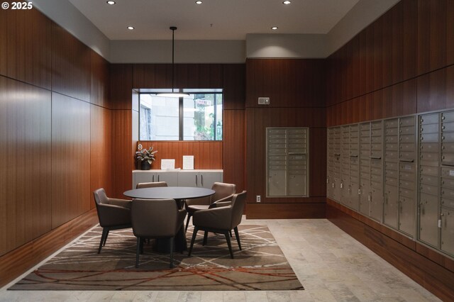dining area with mail area, recessed lighting, and wooden walls