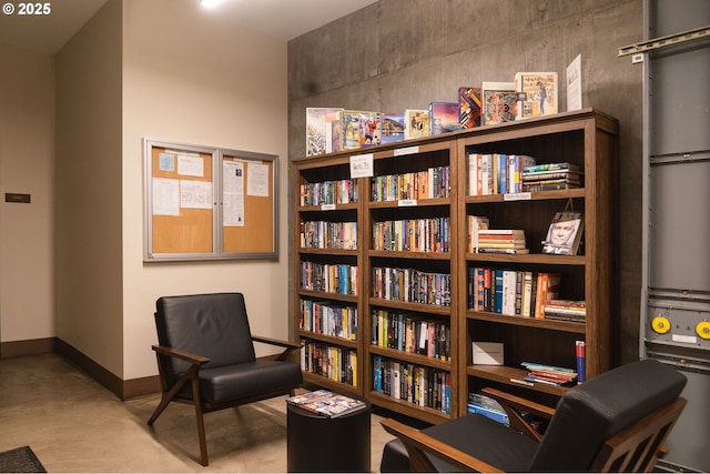 living area featuring baseboards
